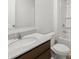Bathroom with granite countertop, dark cabinets, and tub with shower at 131 Hampton Ter, Dallas, GA 30157