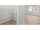 Spacious walk-in closet with wire shelving next to a room with luxury vinyl floors at 131 Hampton Ter, Dallas, GA 30157