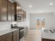 Well-lit kitchen featuring sleek appliances, stylish backsplash, and wood cabinets at 131 Hampton Ter, Dallas, GA 30157