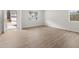 Spacious living area with ample natural light, light wood-look flooring, and views of the front yard at 171 Hampton Ter, Dallas, GA 30157