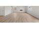 Bright living room offering great natural light, wood-look floors, and modern electric fireplace at 171 Hampton Ter, Dallas, GA 30157