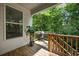 Back porch with a gas grill, wooden floors and railings, surrounded by lush greenery at 2136 Oak Knob Dr, Decatur, GA 30032