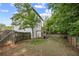 A spacious backyard with a fire pit, wooden pergola, lawn and privacy fence at 2136 Oak Knob Dr, Decatur, GA 30032