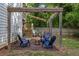 Backyard fire pit with Adirondack chairs and wooden pergola and lush lawn at 2136 Oak Knob Dr, Decatur, GA 30032