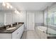 Bright bathroom featuring double vanity, granite counters, soaking tub with tile surround, and a neutral color palette at 2136 Oak Knob Dr, Decatur, GA 30032