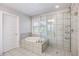 Bright bathroom featuring a soaking tub with tile surround, glass shower and a neutral color palette at 2136 Oak Knob Dr, Decatur, GA 30032