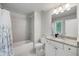 Bright bathroom with granite countertop, white cabinetry, and shower-tub combo at 2136 Oak Knob Dr, Decatur, GA 30032