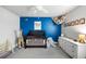 Bright Bedroom featuring a crib, a giraffe, a blue accent wall, and carpeted floors at 2136 Oak Knob Dr, Decatur, GA 30032