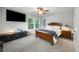 Cozy bedroom with a ceiling fan, television, and large windows for natural light at 2136 Oak Knob Dr, Decatur, GA 30032