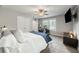 Well-lit bedroom featuring an exercise bike, ceiling fan, and a large window at 2136 Oak Knob Dr, Decatur, GA 30032