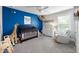 Bright Bedroom featuring a crib, a chair, a giraffe, blue accent wall, and carpeted floors at 2136 Oak Knob Dr, Decatur, GA 30032