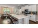 Open-concept kitchen boasts a large island with seating, stainless appliances, and wood paneling at 2136 Oak Knob Dr, Decatur, GA 30032