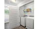 Bright laundry room featuring a washer, dryer, and shelving for storage at 2136 Oak Knob Dr, Decatur, GA 30032