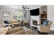 Inviting living room with a fireplace and large windows, offering ample natural light at 2136 Oak Knob Dr, Decatur, GA 30032