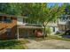 Charming home featuring a stone facade, covered entrance, and mature shade tree at 2294 Salt Springs Pl, Austell, GA 30168