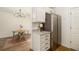 Well-equipped kitchen area with stainless steel refrigerator, granite countertops, and dining area at 2294 Salt Springs Pl, Austell, GA 30168