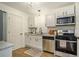 Modern kitchen with stainless steel appliances, white cabinets, and granite countertops at 2294 Salt Springs Pl, Austell, GA 30168