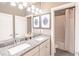 Bathroom with double sink vanity, granite countertop, framed mirrors, and shower/tub combo in an alcove with white tiling at 2675 Sugar Mill Dr, Atlanta, GA 30316