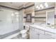 Modern bathroom with a glass-enclosed shower, granite countertop, and a stylish striped wall design with a framed picture at 2675 Sugar Mill Dr, Atlanta, GA 30316