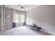 Neutral bedroom featuring a comfortable daybed, plush pillows, and a window with curtains for a cozy and relaxing space at 2675 Sugar Mill Dr, Atlanta, GA 30316