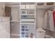 Walk-in closet featuring custom shelving, drawers, and ample storage space for clothing and accessories in a light colored room at 2675 Sugar Mill Dr, Atlanta, GA 30316