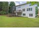 Back exterior view of a two story house with a well-maintained lawn and deck at 2675 Sugar Mill Dr, Atlanta, GA 30316