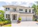Beautiful two-story home featuring a two-car garage, stone accents, and manicured landscaping at 2675 Sugar Mill Dr, Atlanta, GA 30316