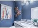 Chic half bathroom featuring modern vanity, granite countertop, and stylish decor at 2675 Sugar Mill Dr, Atlanta, GA 30316
