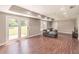 Spacious living room with wood floors, a gray sectional sofa, and French doors leading to the outdoors and a television set at 2675 Sugar Mill Dr, Atlanta, GA 30316