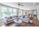 Open living room with hardwood floors, large windows, and view to the kitchen and dining area at 2675 Sugar Mill Dr, Atlanta, GA 30316