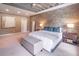 Bright main bedroom featuring a brick accent wall, neutral carpet, and modern furnishings at 2675 Sugar Mill Dr, Atlanta, GA 30316