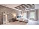 Spacious main bedroom with a brick accent wall, tray ceiling, and generous natural light at 2675 Sugar Mill Dr, Atlanta, GA 30316