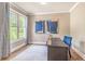 Stylish office with a large window, desk, and comfortable blue chair at 2675 Sugar Mill Dr, Atlanta, GA 30316