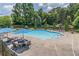 Community pool with lounge chairs and umbrellas on a sunny day at 2675 Sugar Mill Dr, Atlanta, GA 30316