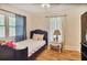 Bedroom with hardwood floors, window, and a comfortable bed with decorative pillows at 4076 Blanton Sw Ave, Atlanta, GA 30331