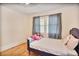 This bedroom offers hardwood floors, a window, and a comfortable bed for relaxation at 4076 Blanton Sw Ave, Atlanta, GA 30331