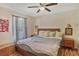 Comfortable bedroom with hardwood floors, ceiling fan, and natural light from the window at 4076 Blanton Sw Ave, Atlanta, GA 30331