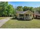 View of the home with a quaint front yard and a detached garage at 4076 Blanton Sw Ave, Atlanta, GA 30331