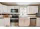 Bright kitchen featuring stainless steel appliances, granite countertops, and white cabinetry at 4076 Blanton Sw Ave, Atlanta, GA 30331