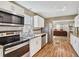 Charming kitchen with hardwood floors, stainless steel appliances, and modern white cabinetry at 4076 Blanton Sw Ave, Atlanta, GA 30331