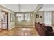 Open-concept living and dining area with hardwood floors and ample natural light at 4076 Blanton Sw Ave, Atlanta, GA 30331