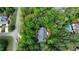Stunning aerial view of home nestled in mature trees, with a pool nearby at 415 Morgan Falls Chase, Canton, GA 30114