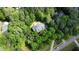 Overhead view of the home nestled among mature trees, featuring a driveway and lush surroundings at 415 Morgan Falls Chase, Canton, GA 30114