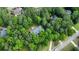 Beautiful aerial view of a home nestled in a lush, green, wooded lot at 415 Morgan Falls Chase, Canton, GA 30114