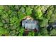 Aerial view of the home, lush trees, roof, driveway and surrounding landscape at 415 Morgan Falls Chase, Canton, GA 30114