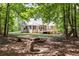 Expansive backyard featuring a wooden deck, lush trees, and fire pit perfect for outdoor entertaining at 415 Morgan Falls Chase, Canton, GA 30114