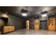 A spacious basement area with an open floor plan, a wet bar, and custom built-in shelving units, providing ample storage at 415 Morgan Falls Chase, Canton, GA 30114