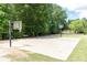 Outdoor community basketball court surrounded by mature trees and manicured green spaces at 415 Morgan Falls Chase, Canton, GA 30114