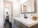 Neutral bathroom featuring wood vanity, black hardware, bright white counter, and tile flooring at 415 Morgan Falls Chase, Canton, GA 30114
