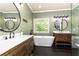 Ensuite bathroom featuring modern fixtures, large soaking tub, and sinks, and a window view at 415 Morgan Falls Chase, Canton, GA 30114